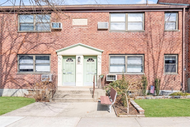 townhome / multi-family property with brick siding