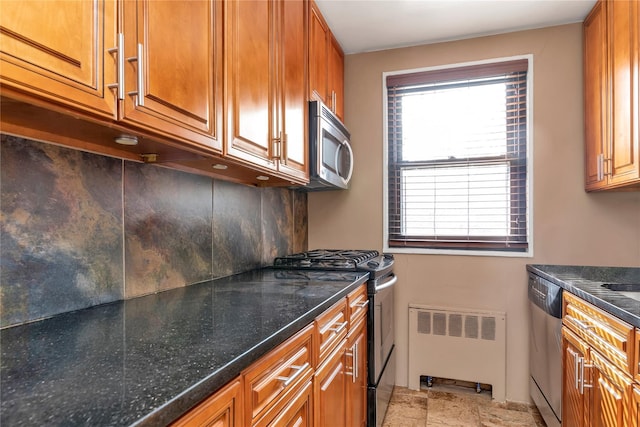 kitchen with brown cabinetry, appliances with stainless steel finishes, and radiator heating unit