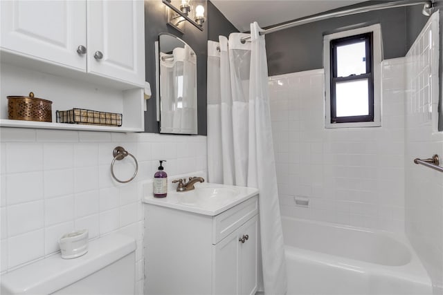 bathroom featuring toilet, tile walls, vanity, and shower / bath combination with curtain