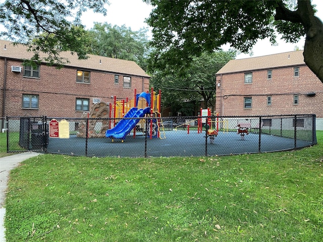 communal playground with a yard and fence