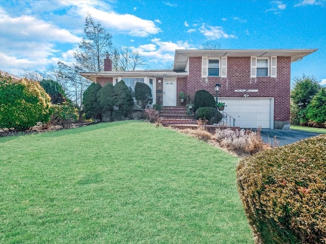 tri-level home featuring brick siding, a chimney, a front yard, a garage, and driveway