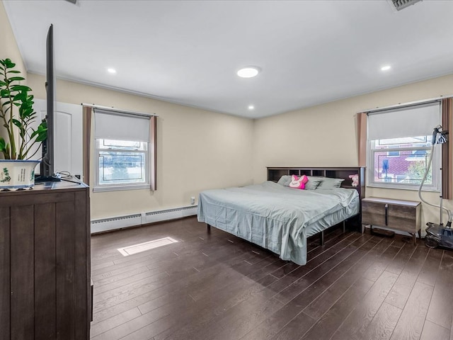 bedroom with recessed lighting, dark wood finished floors, and baseboard heating