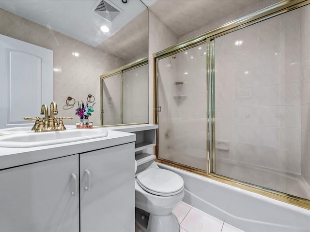 full bath with tile walls, visible vents, toilet, enclosed tub / shower combo, and tile patterned flooring