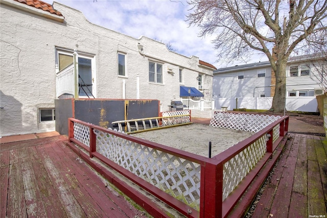 deck featuring a grill and fence