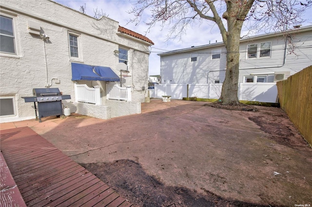 back of property with a patio area, a fenced backyard, a tiled roof, and stucco siding
