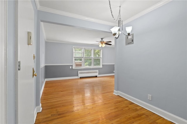 unfurnished dining area with radiator, baseboards, crown molding, and light wood-style floors