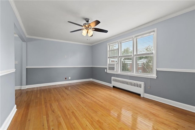 unfurnished room with radiator, crown molding, baseboards, and hardwood / wood-style floors