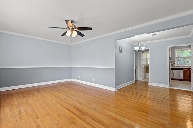 empty room featuring baseboards, light wood-style flooring, crown molding, and ceiling fan with notable chandelier