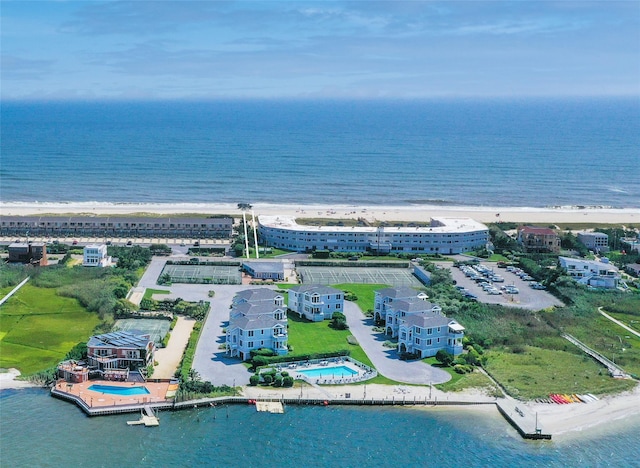 birds eye view of property with a water view and a view of the beach