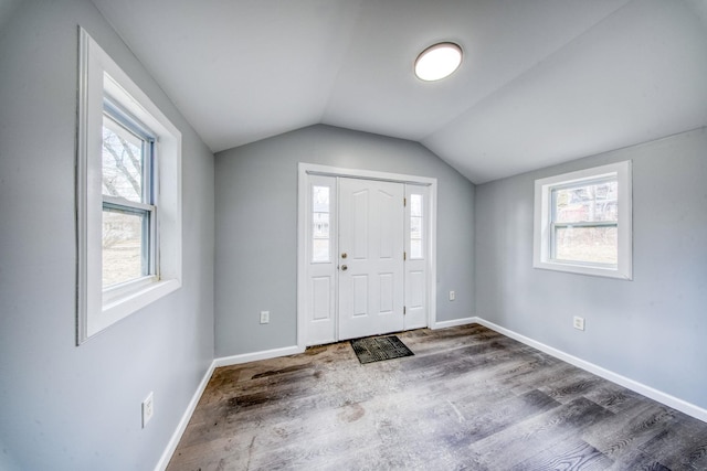 entrance foyer featuring baseboards, lofted ceiling, and dark wood-type flooring