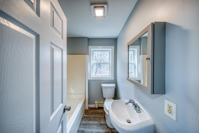 full bathroom with toilet, a sink, wood finished floors, a bathtub, and walk in shower