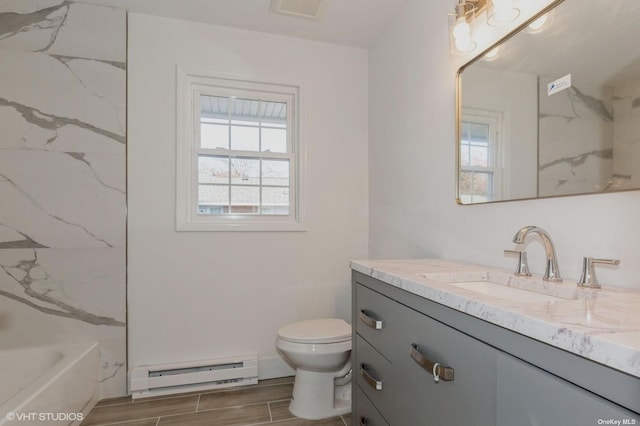 full bathroom with visible vents, plenty of natural light, baseboard heating, and vanity