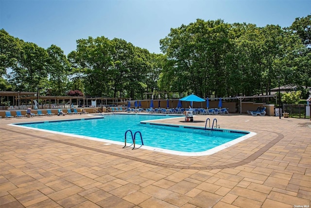 community pool featuring a patio area and fence