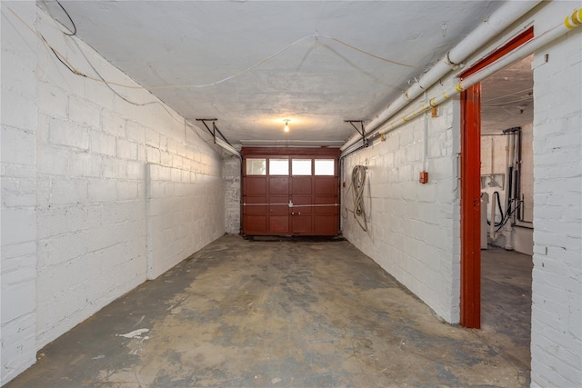 garage with washer / clothes dryer and concrete block wall