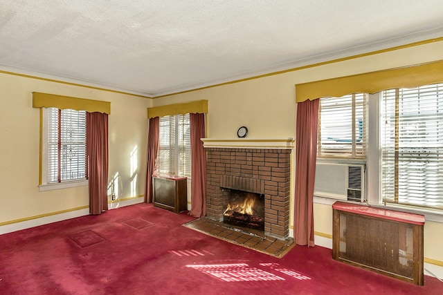 unfurnished living room with radiator heating unit, a fireplace, and a wealth of natural light