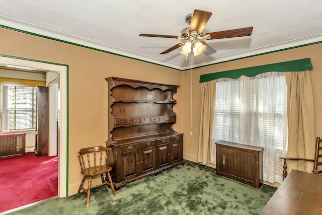 interior space with crown molding, a ceiling fan, and carpet floors