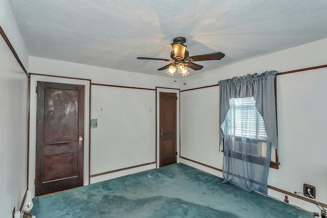 unfurnished bedroom with baseboards, ceiling fan, a textured ceiling, and carpet