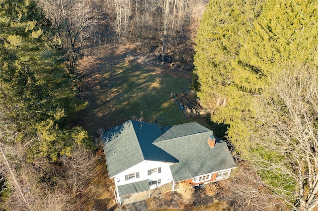 drone / aerial view with a wooded view