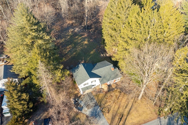 birds eye view of property with a view of trees