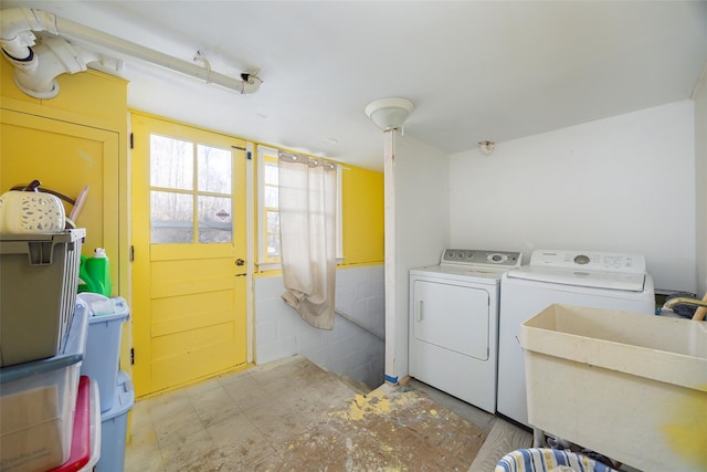 laundry area featuring a sink, separate washer and dryer, and laundry area