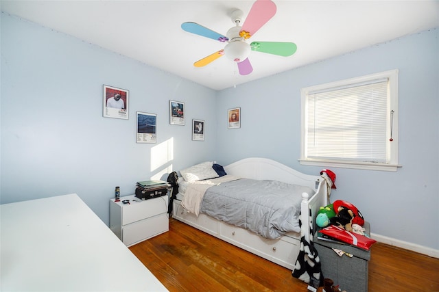 bedroom with baseboards, wood finished floors, and a ceiling fan