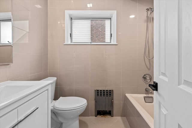 full bath featuring toilet, radiator heating unit, tile walls, and vanity