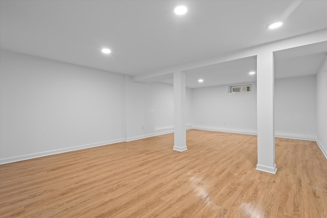 finished basement with light wood-style floors, baseboards, and recessed lighting