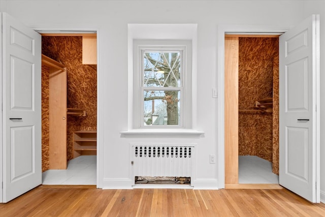 53-31 212th St, Bayside, NY 11364 - unfurnished bedroom with radiator heating unit and wood finished floors