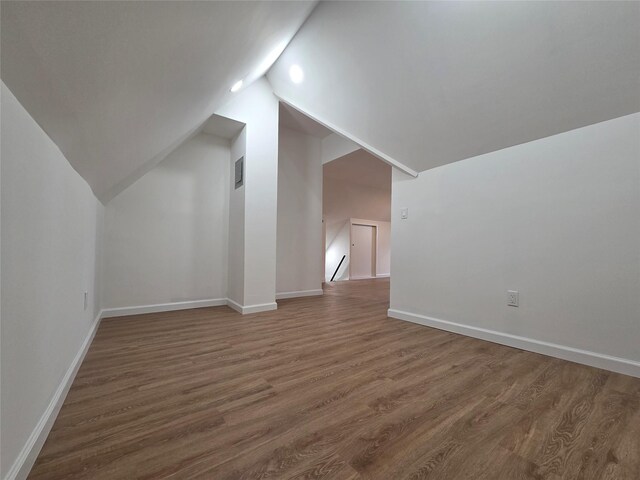53-31 212th St, Bayside, NY 11364 - additional living space featuring wood finished floors, vaulted ceiling, and baseboards