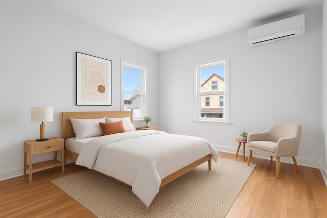53-31 212th St, Bayside, NY 11364 - bedroom featuring an AC wall unit and light wood-style floors