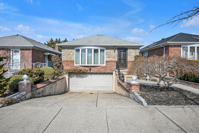 view of front facade with a garage, concrete driveway, brick siding, and stone siding