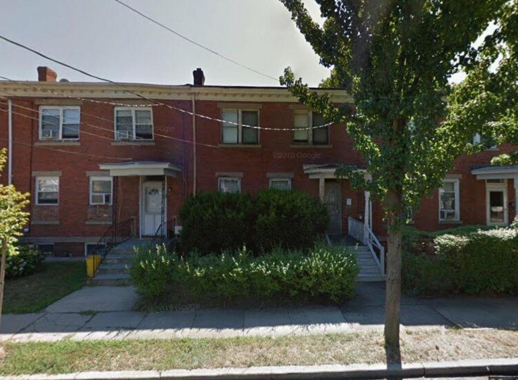 view of property with brick siding