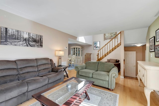 living area with stairway and light wood-style flooring