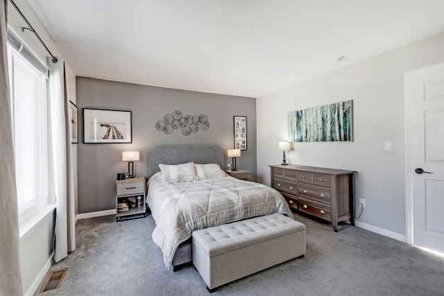 bedroom featuring light carpet, baseboards, and visible vents