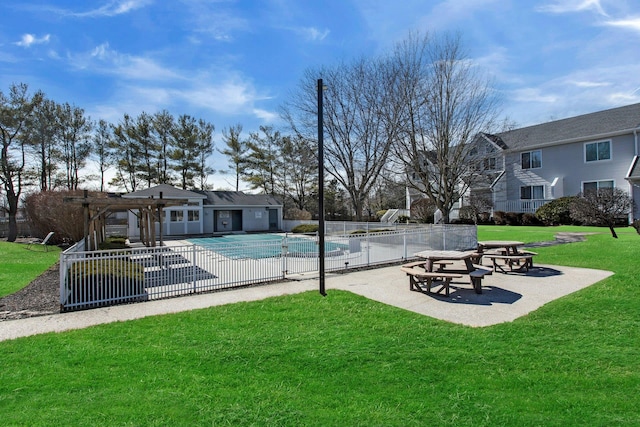 pool featuring a lawn, a patio area, fence, and a pergola