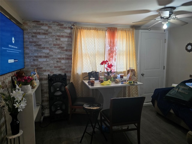 dining space with a ceiling fan and wood finished floors