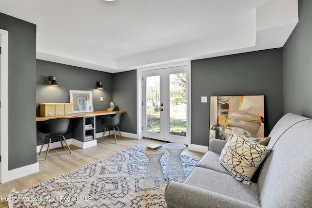 office featuring french doors, wood finished floors, and baseboards