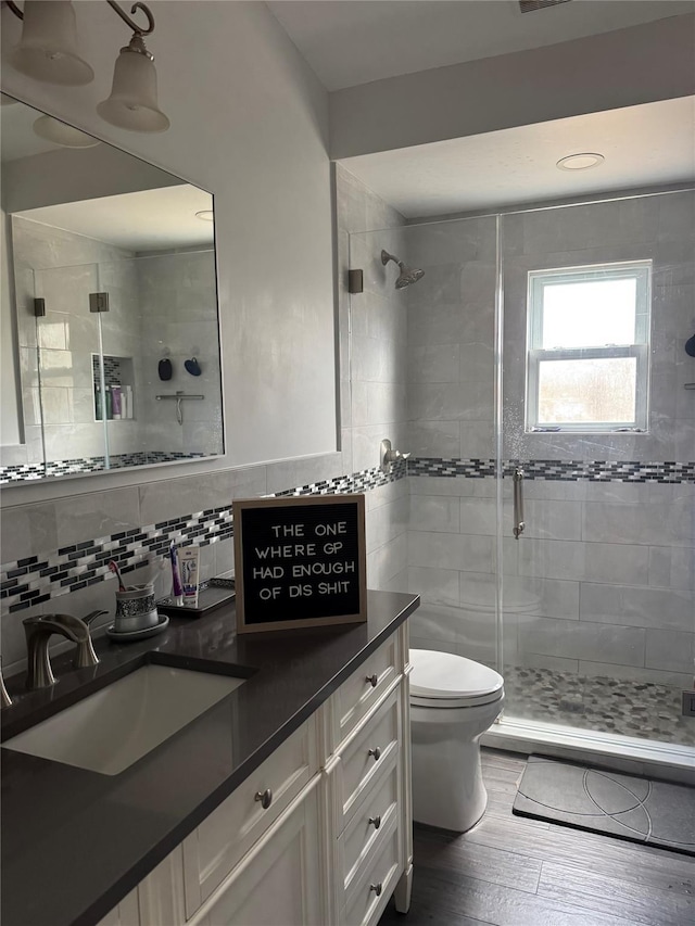 109 Virginia Ave, Lake Grove, NY 11755 - full bathroom with tasteful backsplash, vanity, toilet, a shower stall, and wood finished floors