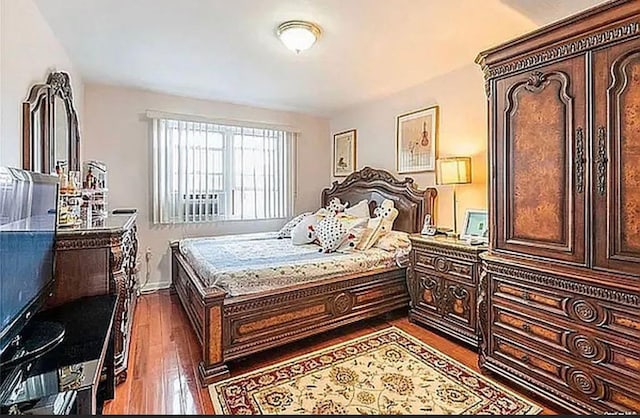 bedroom with dark wood finished floors