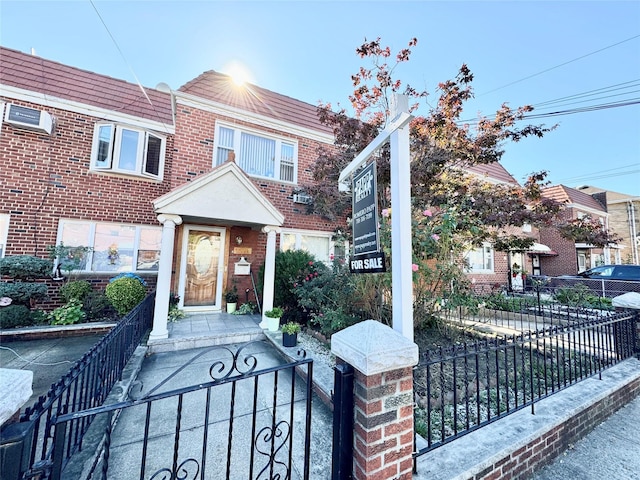 view of property featuring a fenced front yard and brick siding