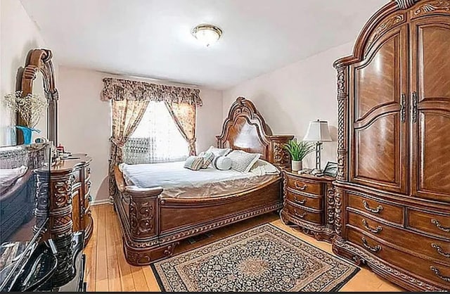 bedroom with wood-type flooring