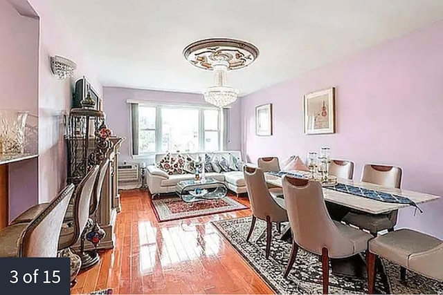 dining area with a notable chandelier and wood finished floors