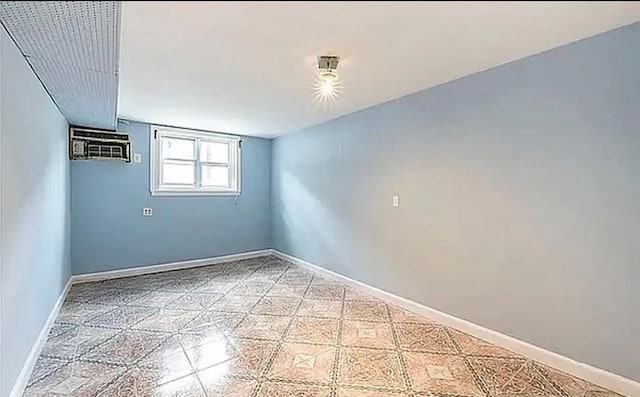 unfurnished room with light floors and baseboards