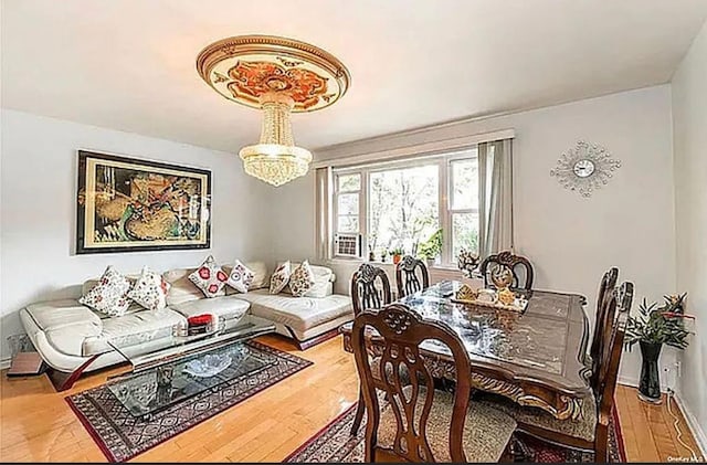 dining room featuring a notable chandelier and wood finished floors