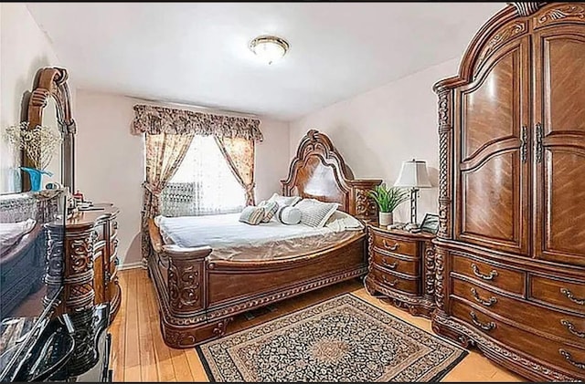 bedroom with light wood-style floors and baseboards