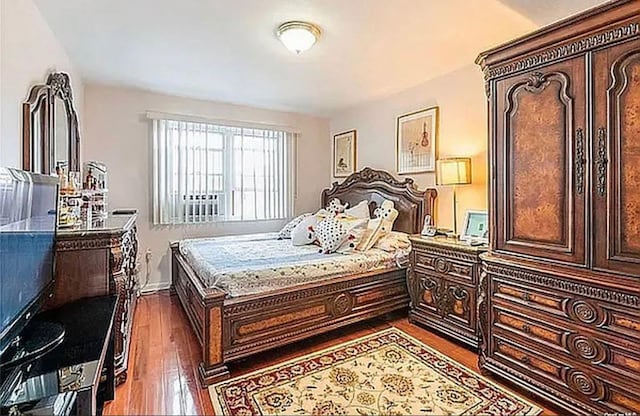 bedroom featuring dark wood-style floors