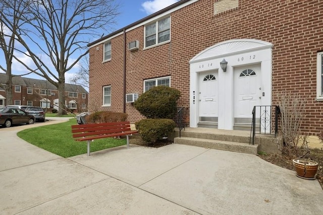 entrance to property featuring brick siding