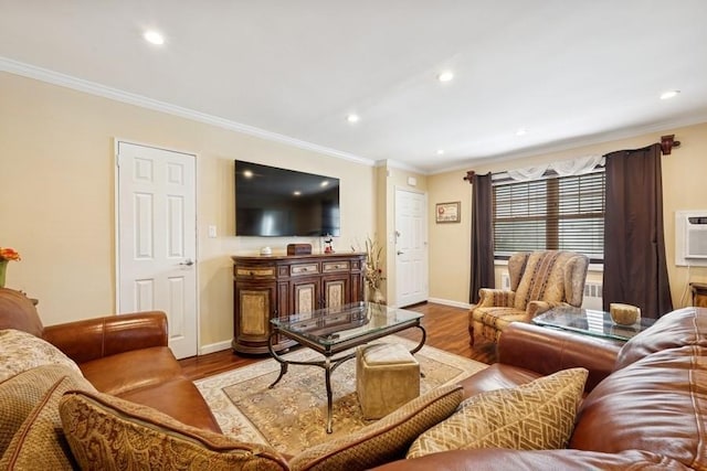 living room with ornamental molding, recessed lighting, wood finished floors, and baseboards