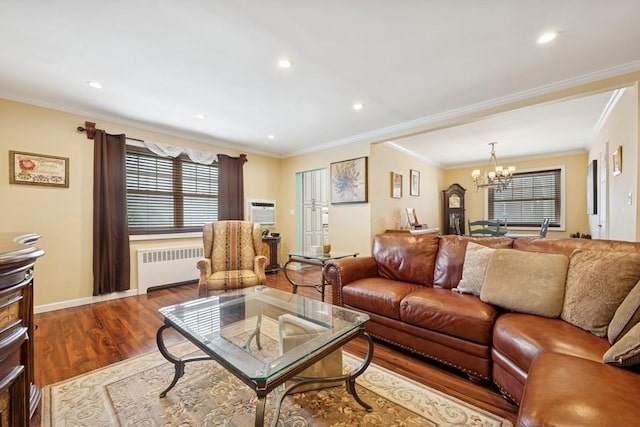 living area featuring dark wood-style flooring, crown molding, a notable chandelier, recessed lighting, and radiator