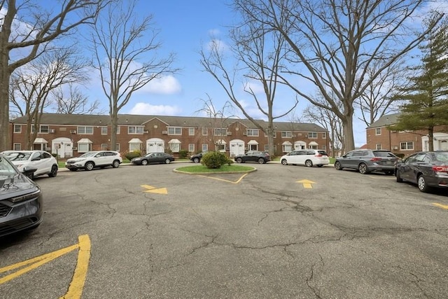 uncovered parking lot featuring a residential view